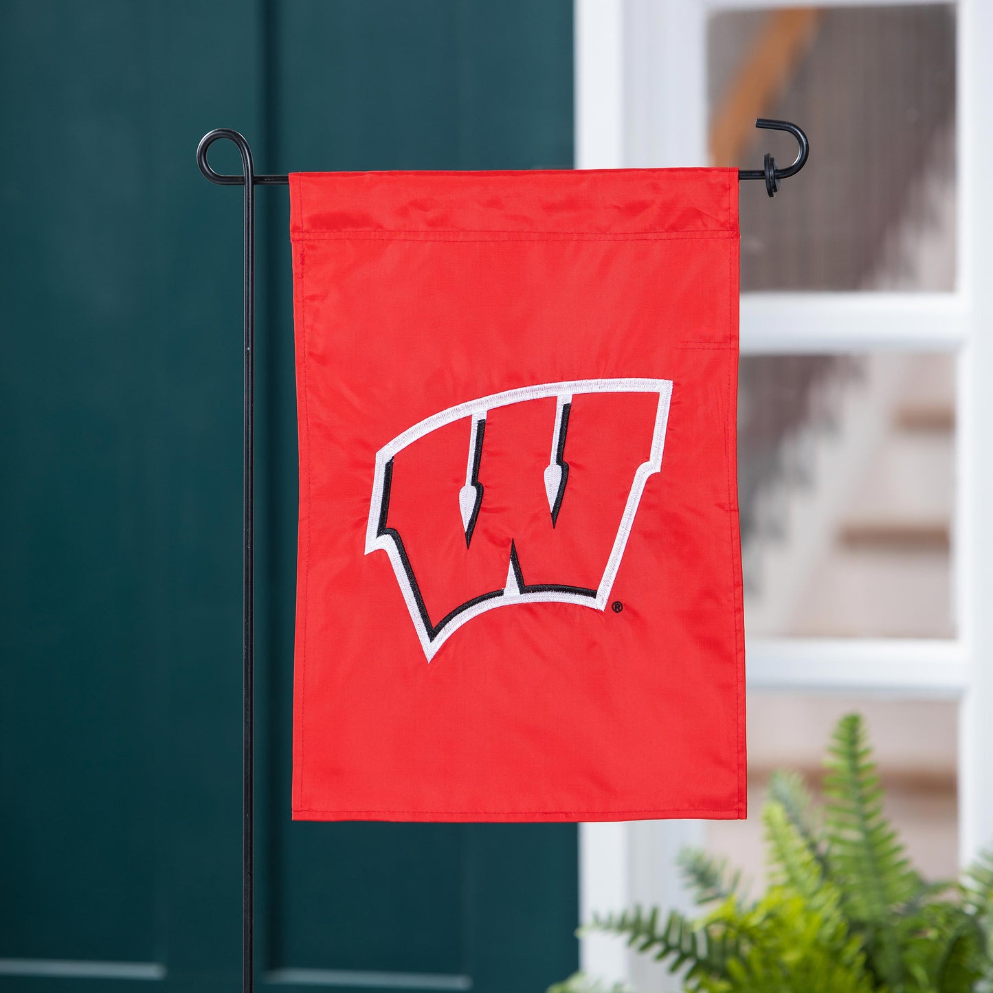 University of Wisconsin-Madison applique garden flag in red with white UW design on a stand on Tampa Home & Garden Store