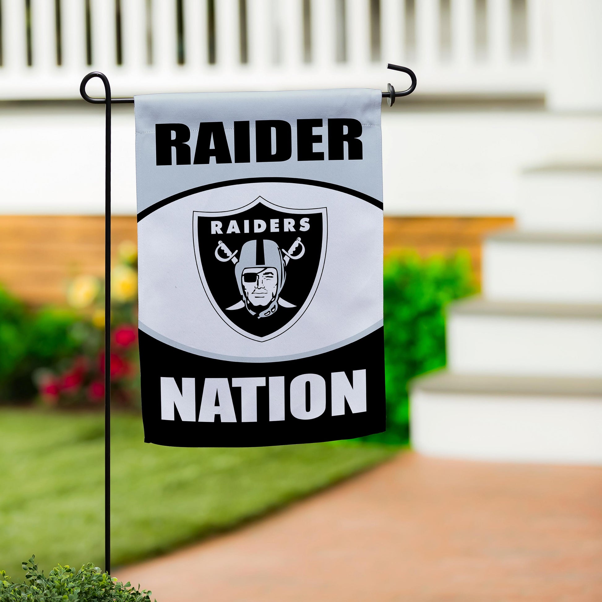 Las Vegas Raiders suede flag on a black metal stake featuring Raiders shield emblem on Tampa Home & Garden Store