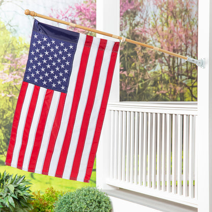 American flag on a 4KD wooden flag pole mounted on a white window frame in a garden on Tampa Home & Garden Store
