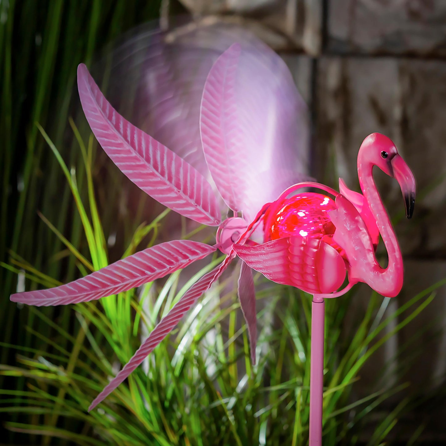 36H Solar Flamingo Staked Wind Spinner with pink blades and translucent wings on pink stake on Tampa Home & Garden Store