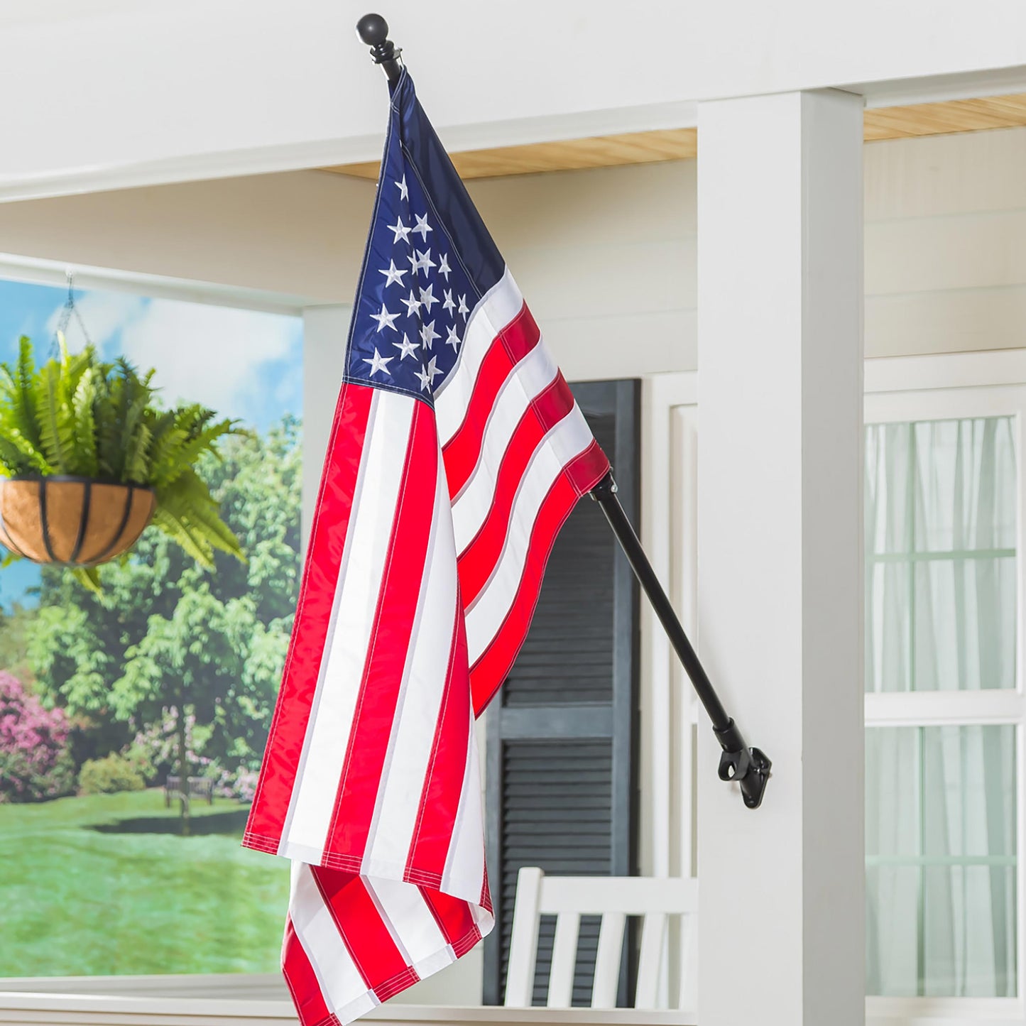 Extendable metal flag pole with black ball finial holding American flag outdoors on Tampa Home & Garden Store