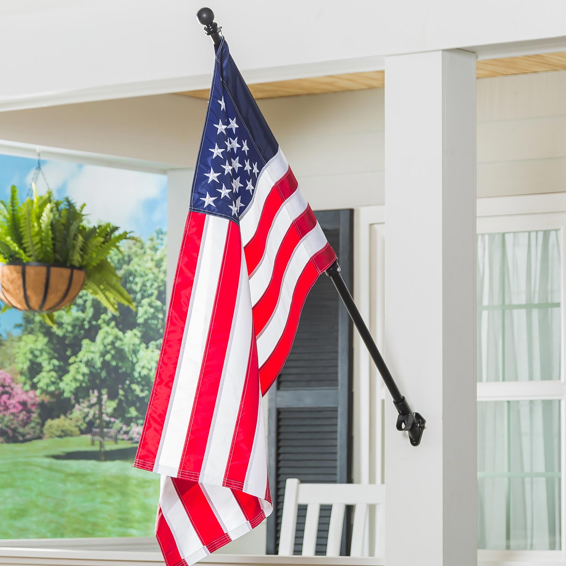 Extendable metal flag pole with black ball finial holding American flag outdoors on Tampa Home & Garden Store