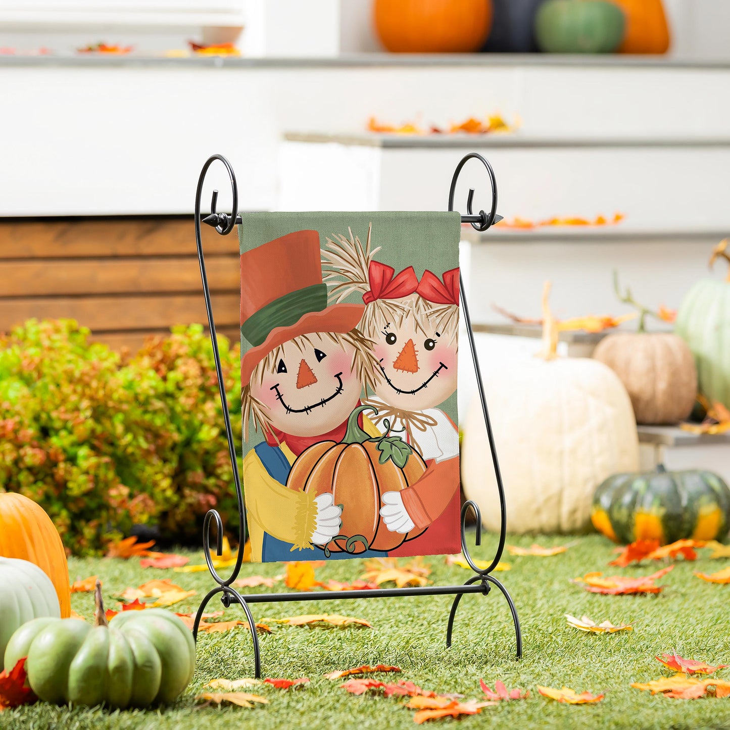 Couple Of Scarecrows Applique Garden Flag with two scarecrows pumpkins and red bows on stand on Tampa Home & Garden Store