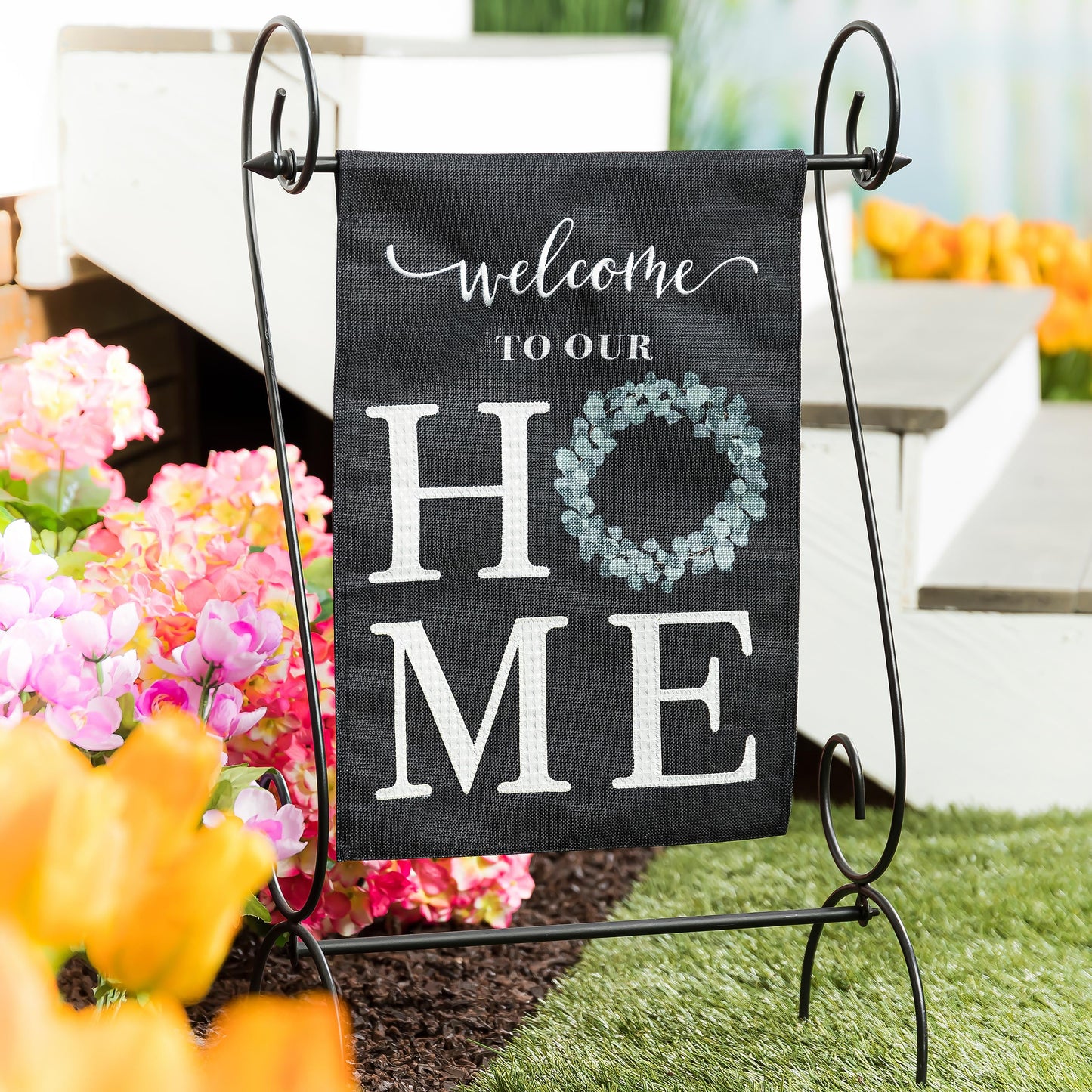Eucalyptus Welcome Burlap Garden Flag on black burlap with script and wreath on metal stand on Tampa Home & Garden Store