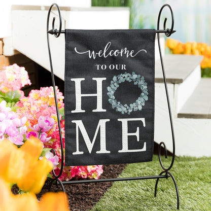 Eucalyptus Welcome Burlap Garden Flag on black burlap with script and wreath on metal stand on Tampa Home & Garden Store