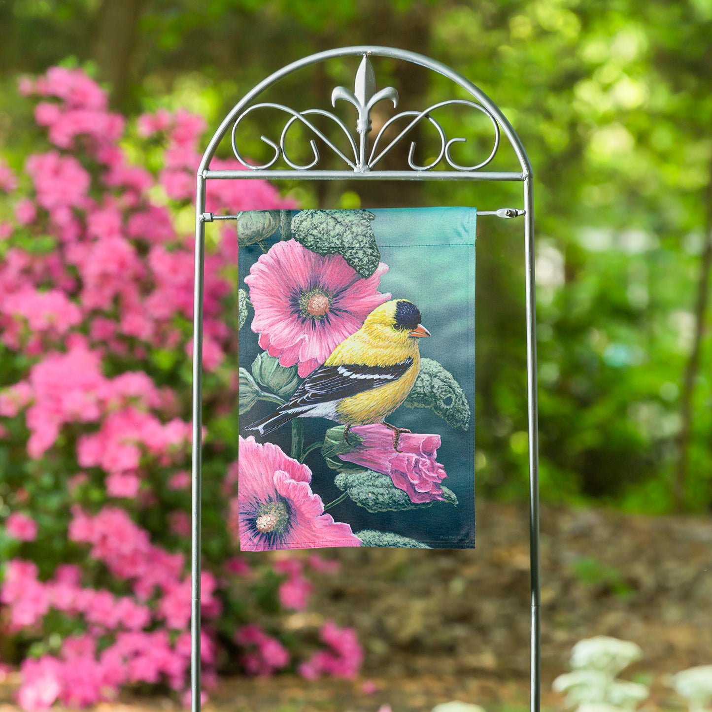 Goldfinch on Hollyhocks suede garden flag with backdrop and pink blooms on a metal stand on Tampa Home & Garden Store
