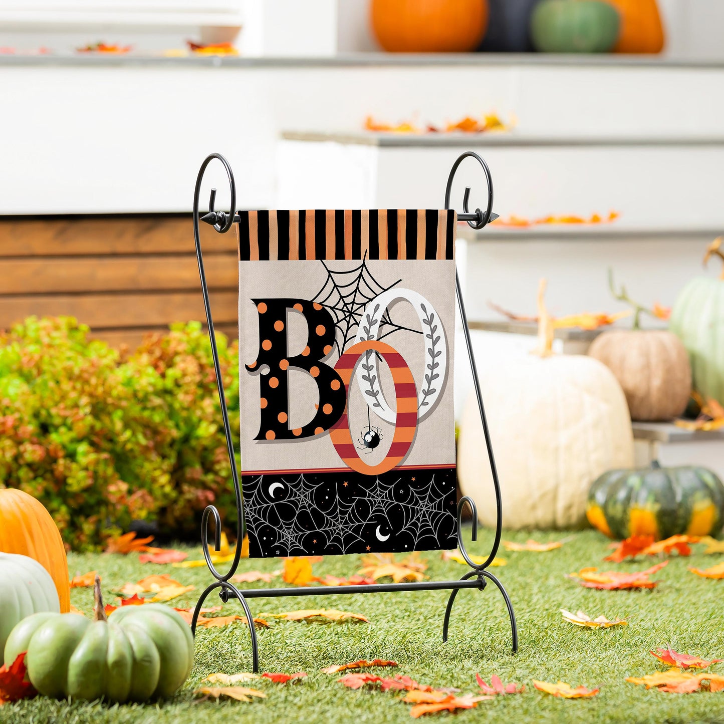 Polka Dots & Stripes Boo Suede Garden Flag on a black metal stand with Halloween motif on Tampa Home & Garden Store