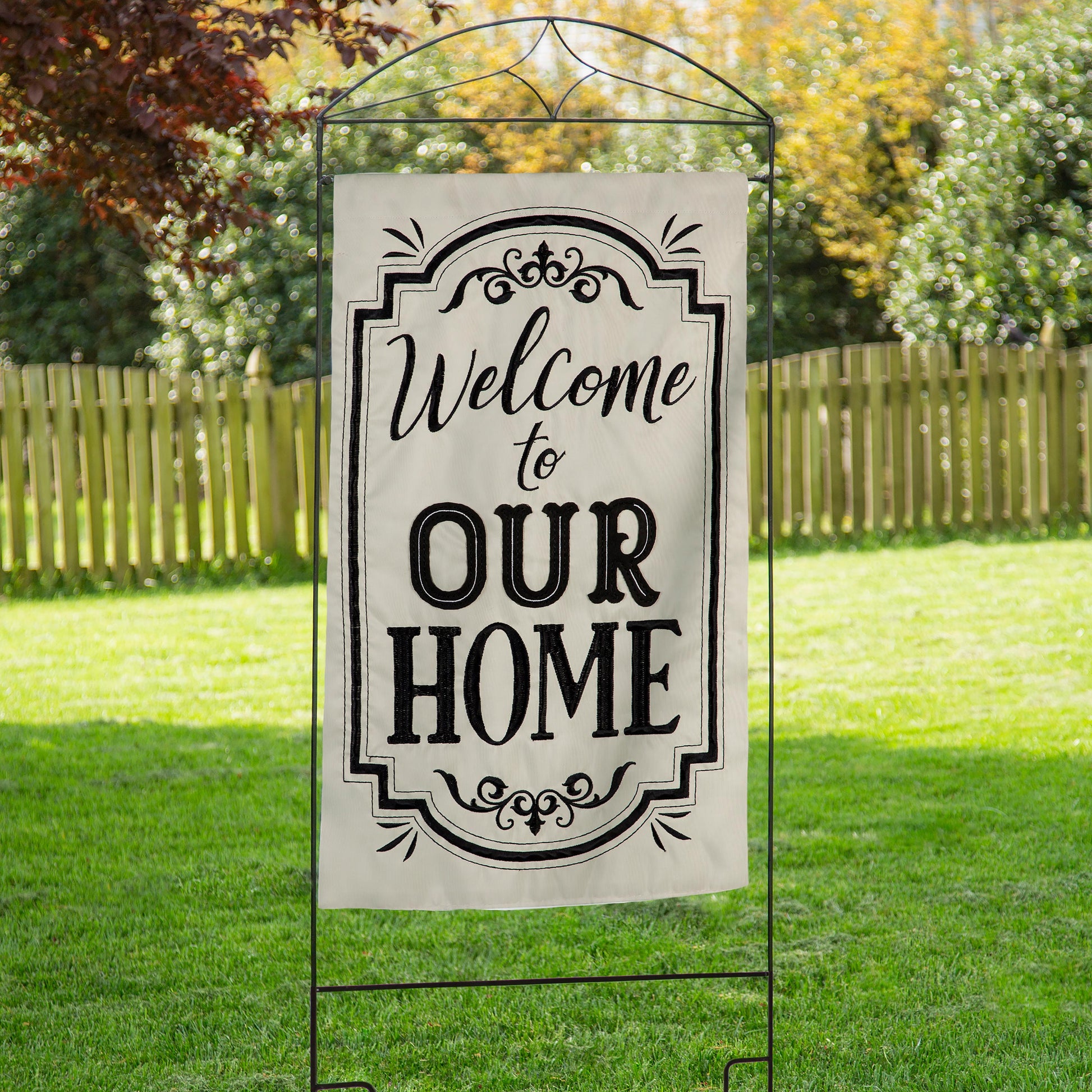 Diamond House Flag Arbor Stand with black metal frame and cream banner reading Welcome to Our Home on Tampa Home & Garden Store