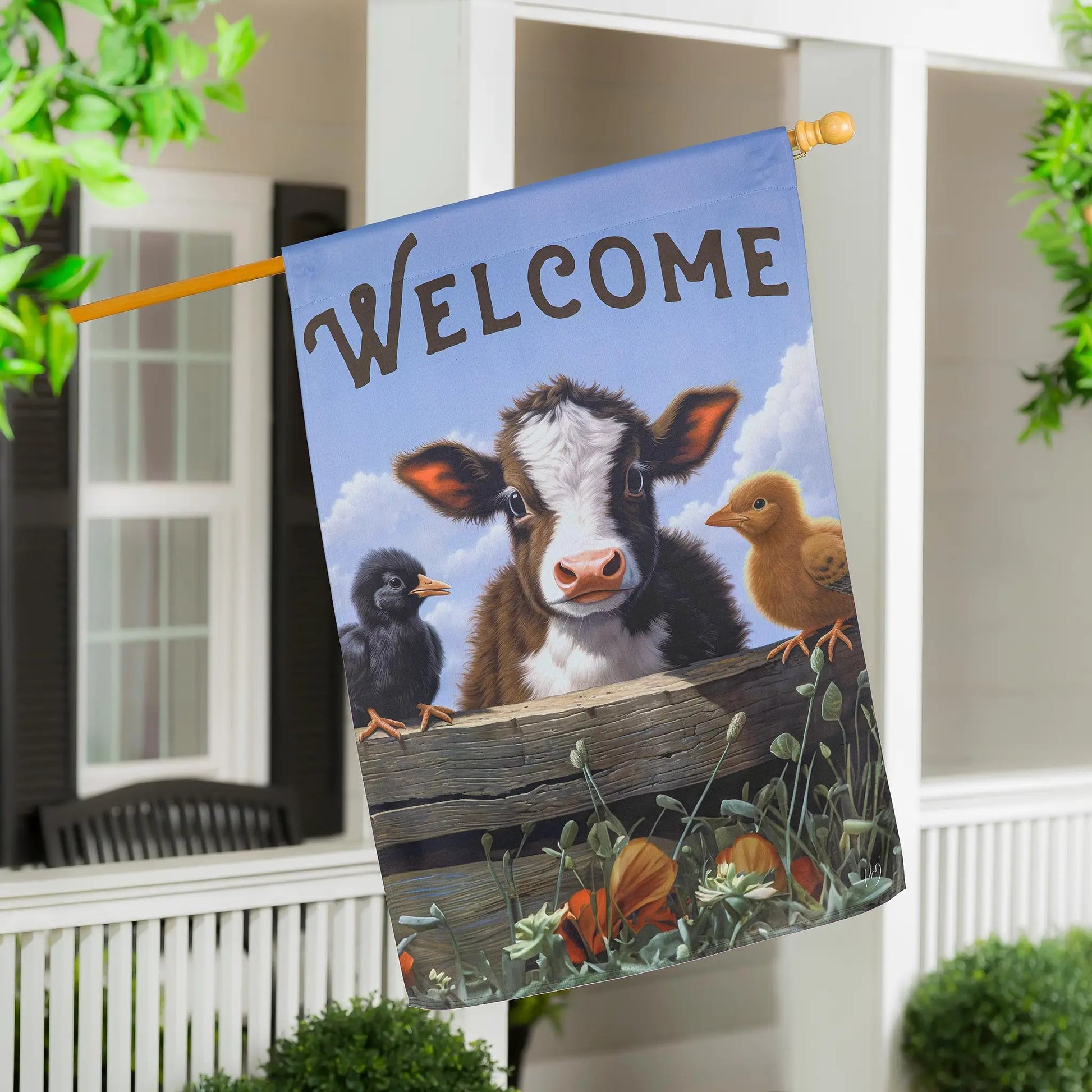 Cow and Chicks suede flag with a welcoming blue banner and flowers on Tampa Home & Garden Store