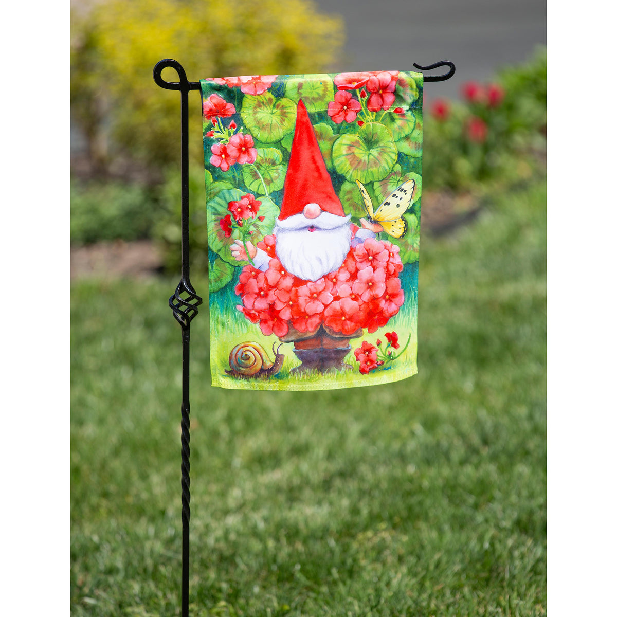 Geranium Gnome Garden Suede Flag with red hat amid pink geraniums and green leaves on Tampa Home & Garden Store