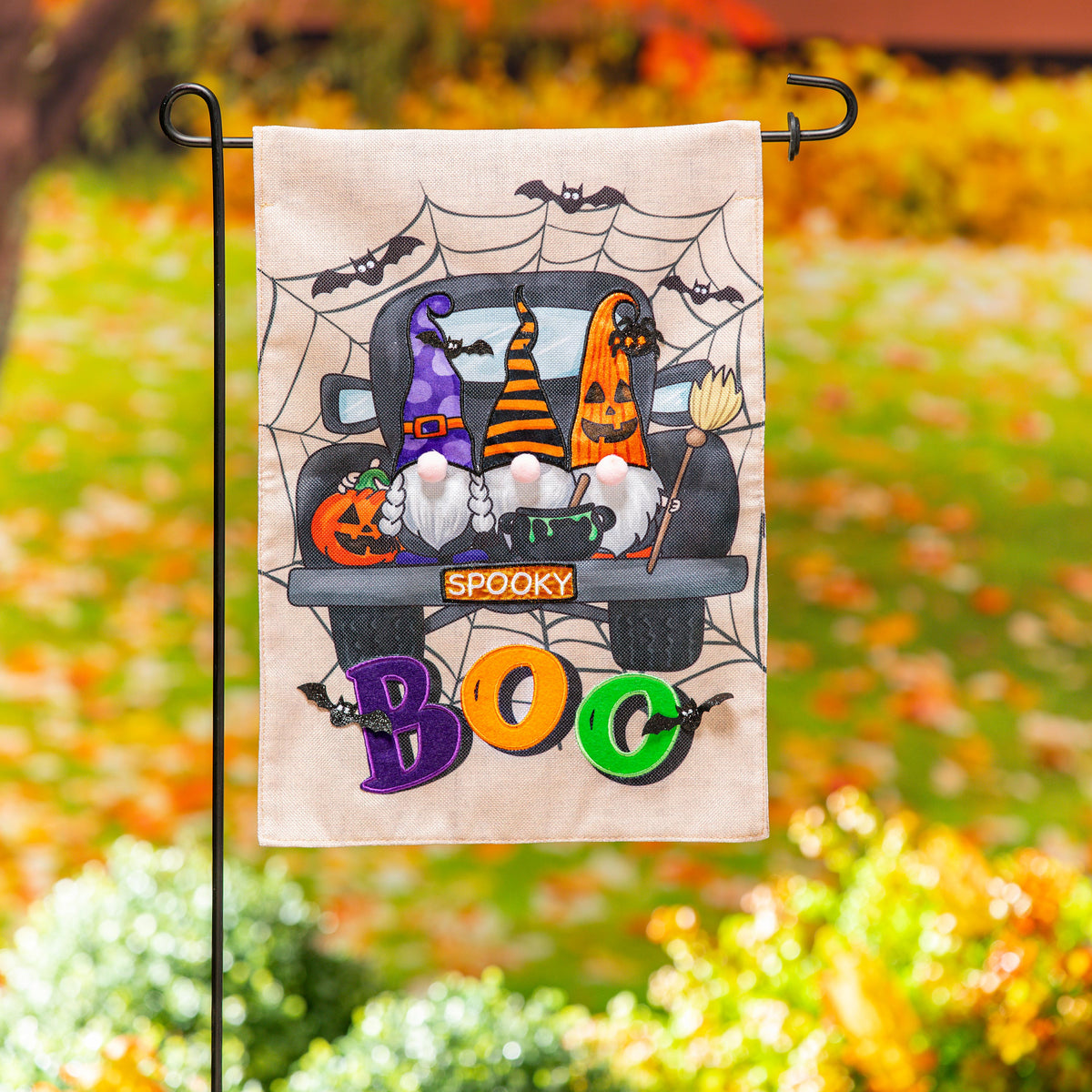 Spooky Truck Burlap Flag featuring Halloween pumpkins, bats, and spiderwebs in tan weave on Tampa Home & Garden Store