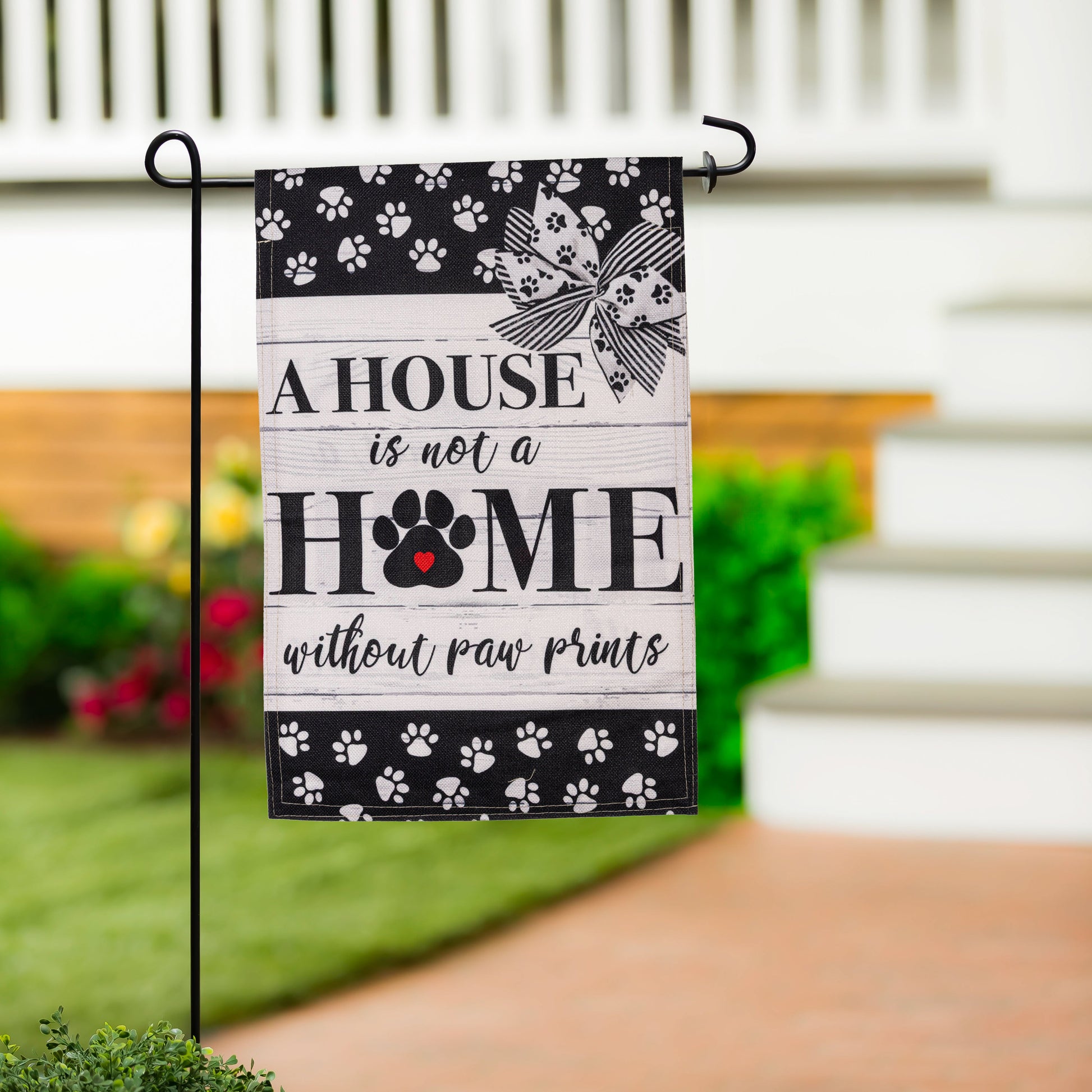 Paw Prints Garden Burlap Flag with white paw prints and a bow on black burlap on Tampa Home & Garden Store