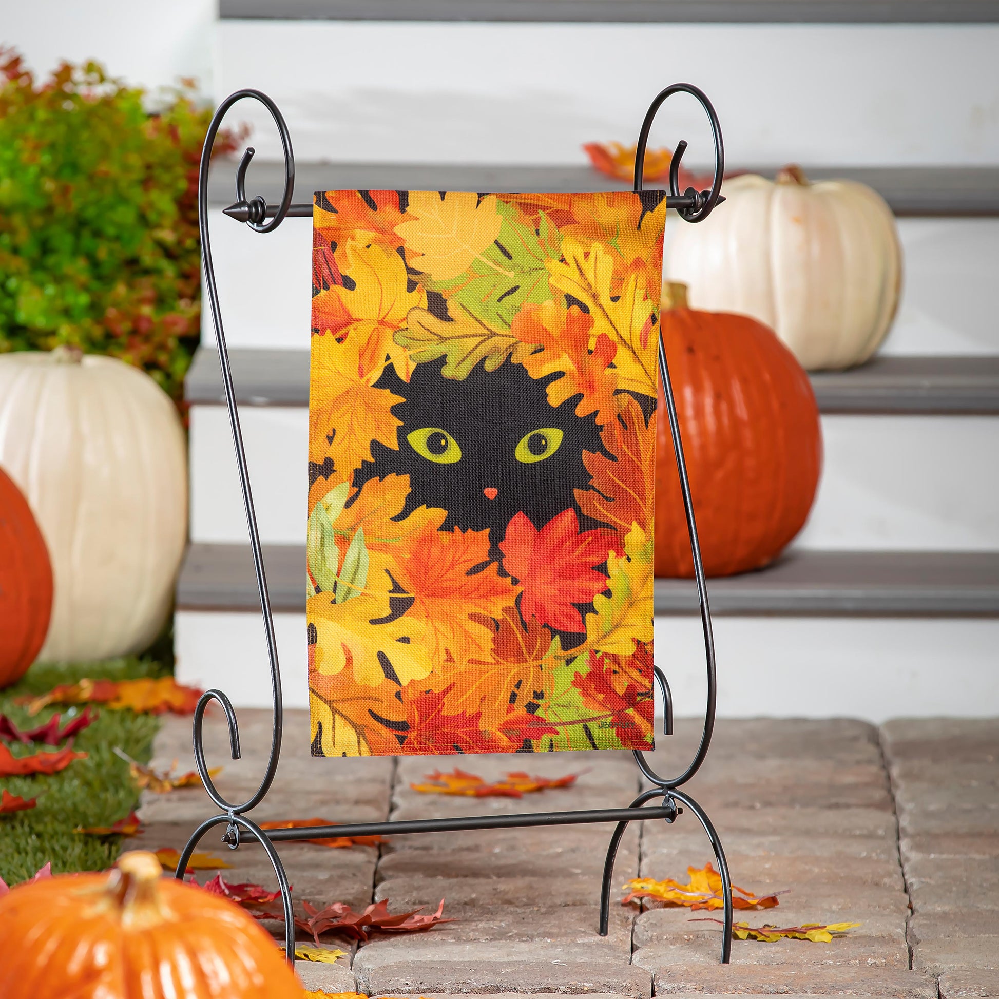 Peekaboo Cat Burlap Garden Flag on metal stand with vibrant autumn leaf design and cat eyes on Tampa Home & Garden Store