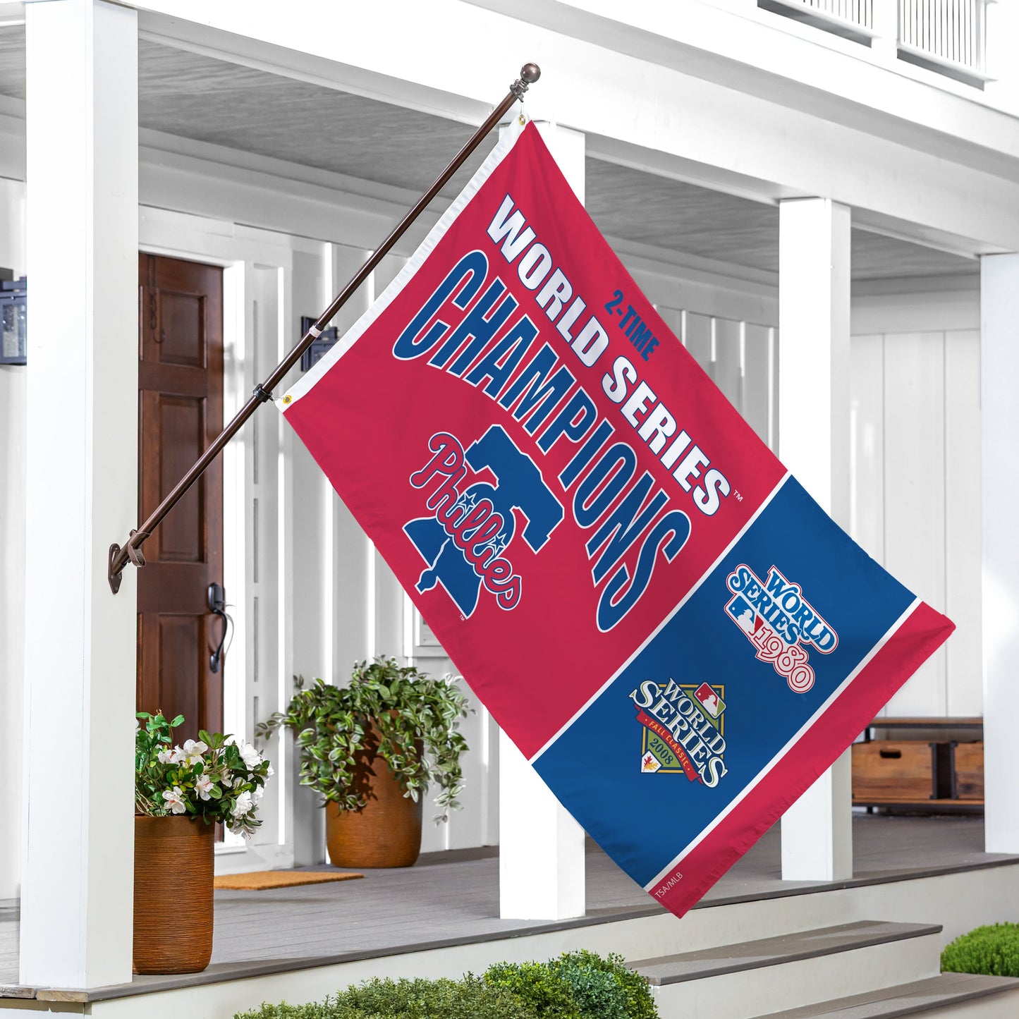 Philadelphia Phillies 3x5 single-sided flag with 2 grommets on a flagpole, displayed on a porch on Tampa Home & Garden Store