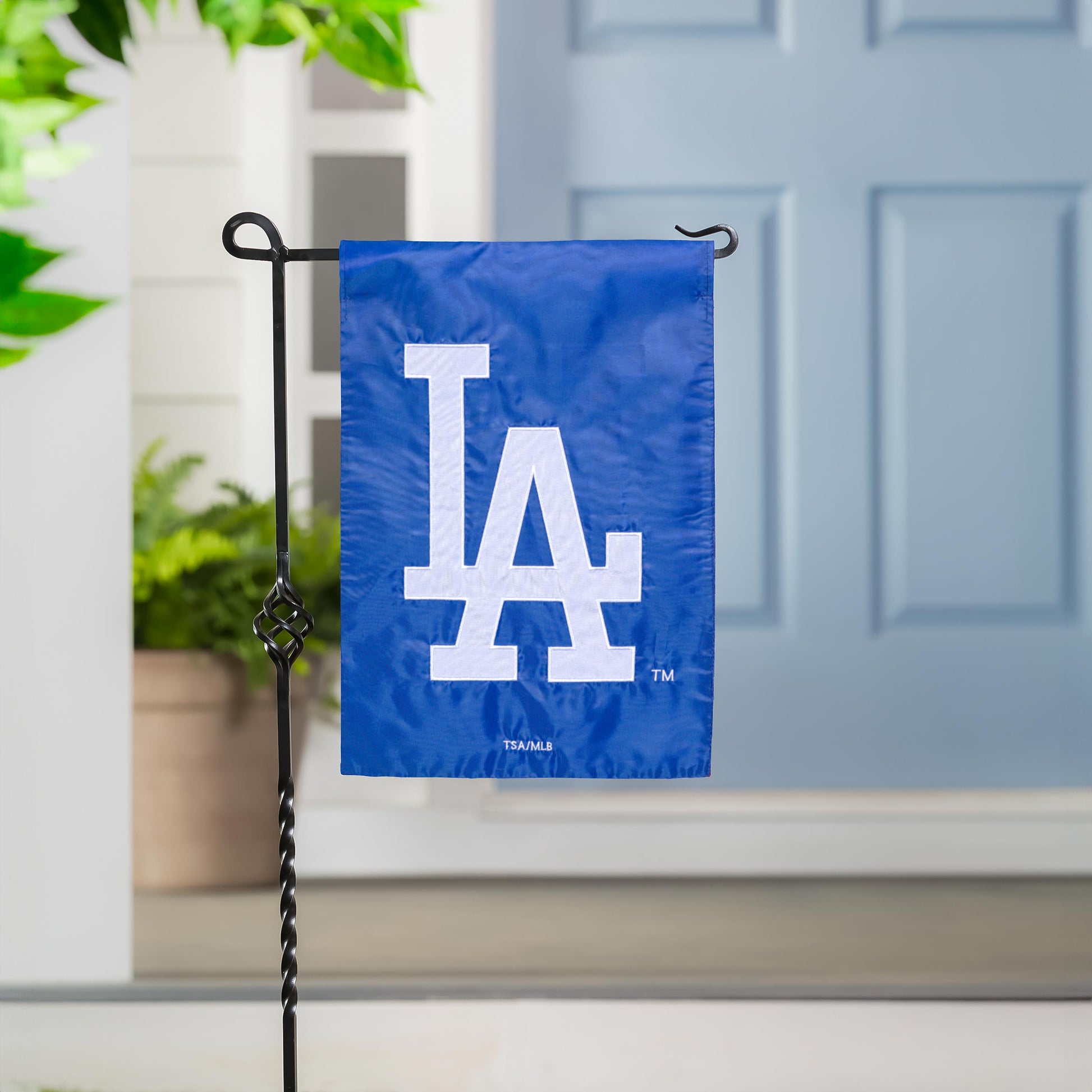 Los Angeles Dodgers blue appliqué garden flag with large white LA letters on a metal stand on Tampa Home & Garden Store