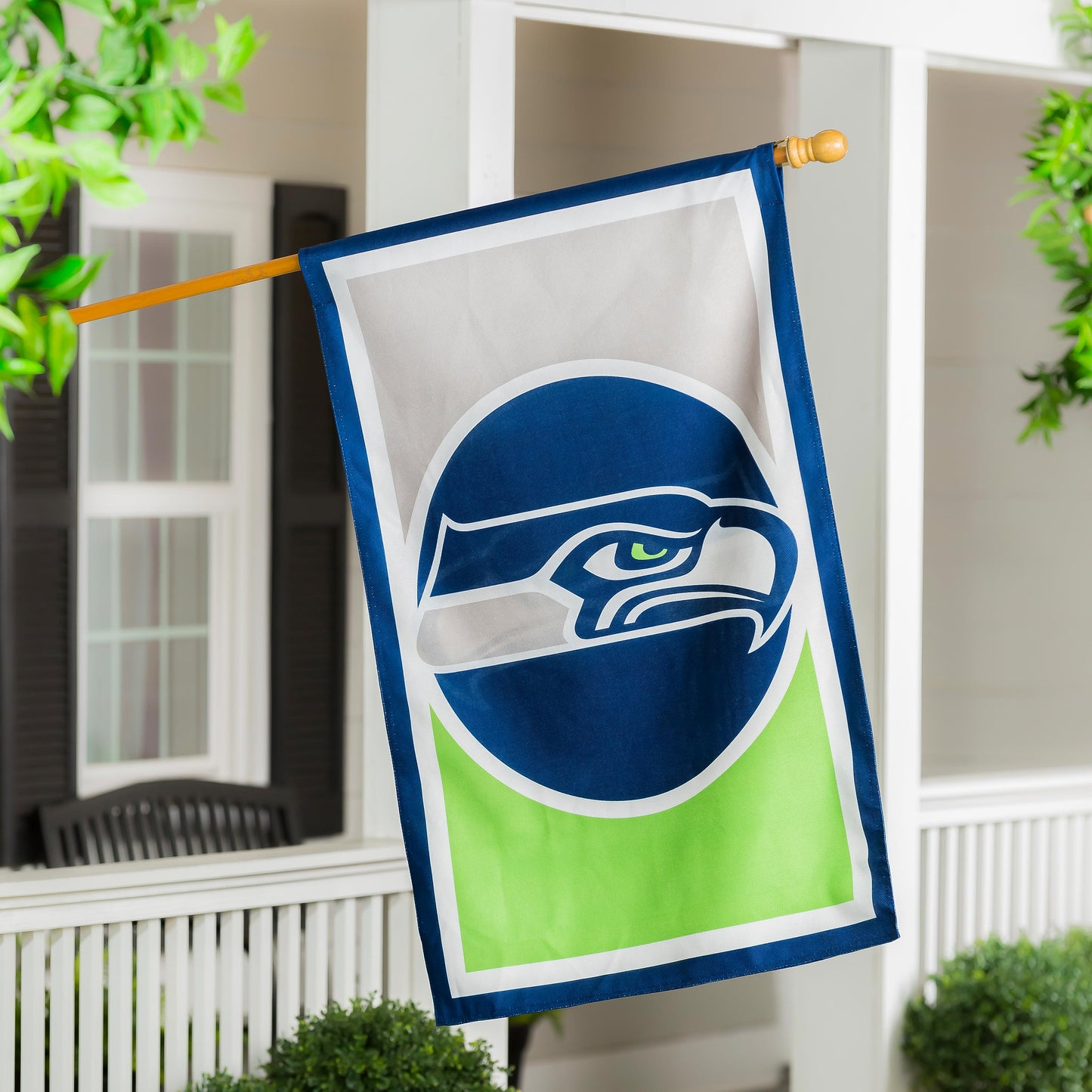 Burlap flag Seattle Seahawks banner with blue border and lime green accent on wooden pole on Tampa Home & Garden Store