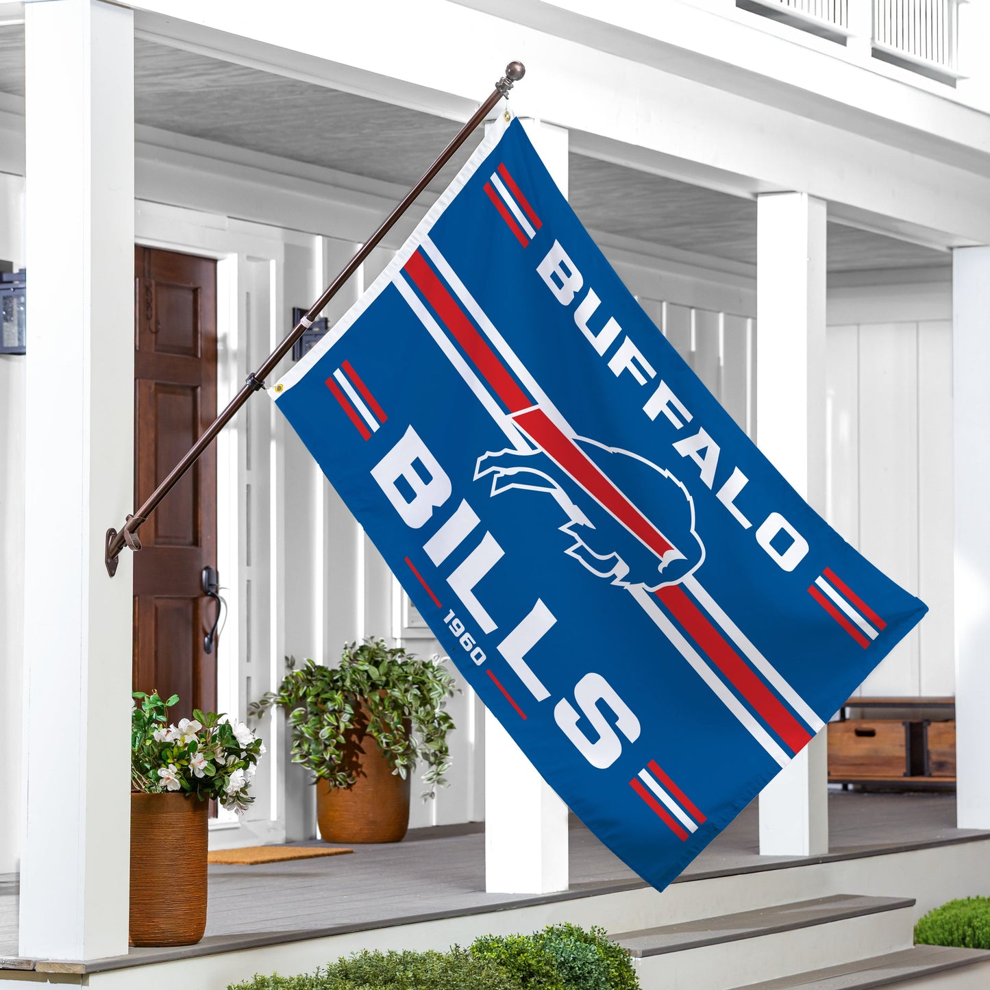 Buffalo Bills single-sided estate flag 3x5, 2 grommets, displayed on flagpole beside porch on Tampa Home & Garden Store
