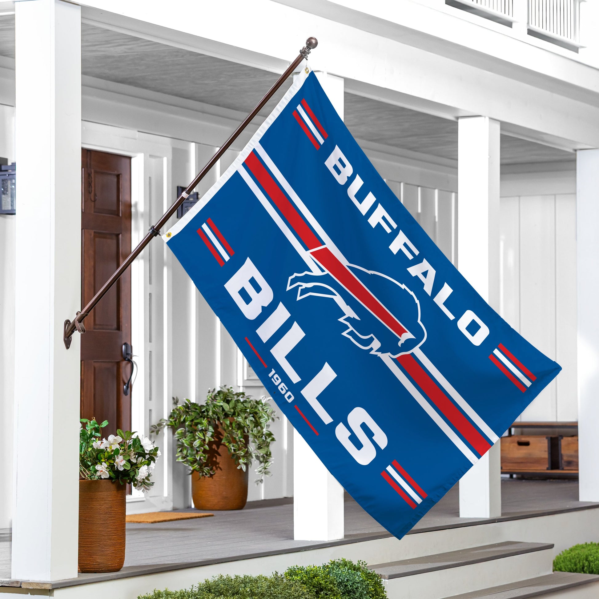 Buffalo Bills single-sided estate flag 3x5, 2 grommets, displayed on flagpole beside porch on Tampa Home & Garden Store