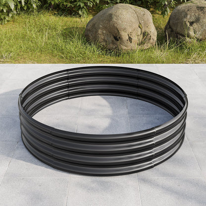 Large black circular metal coil on gray tiled ground with grass and rocks in background on Tampa Home & Garden Store