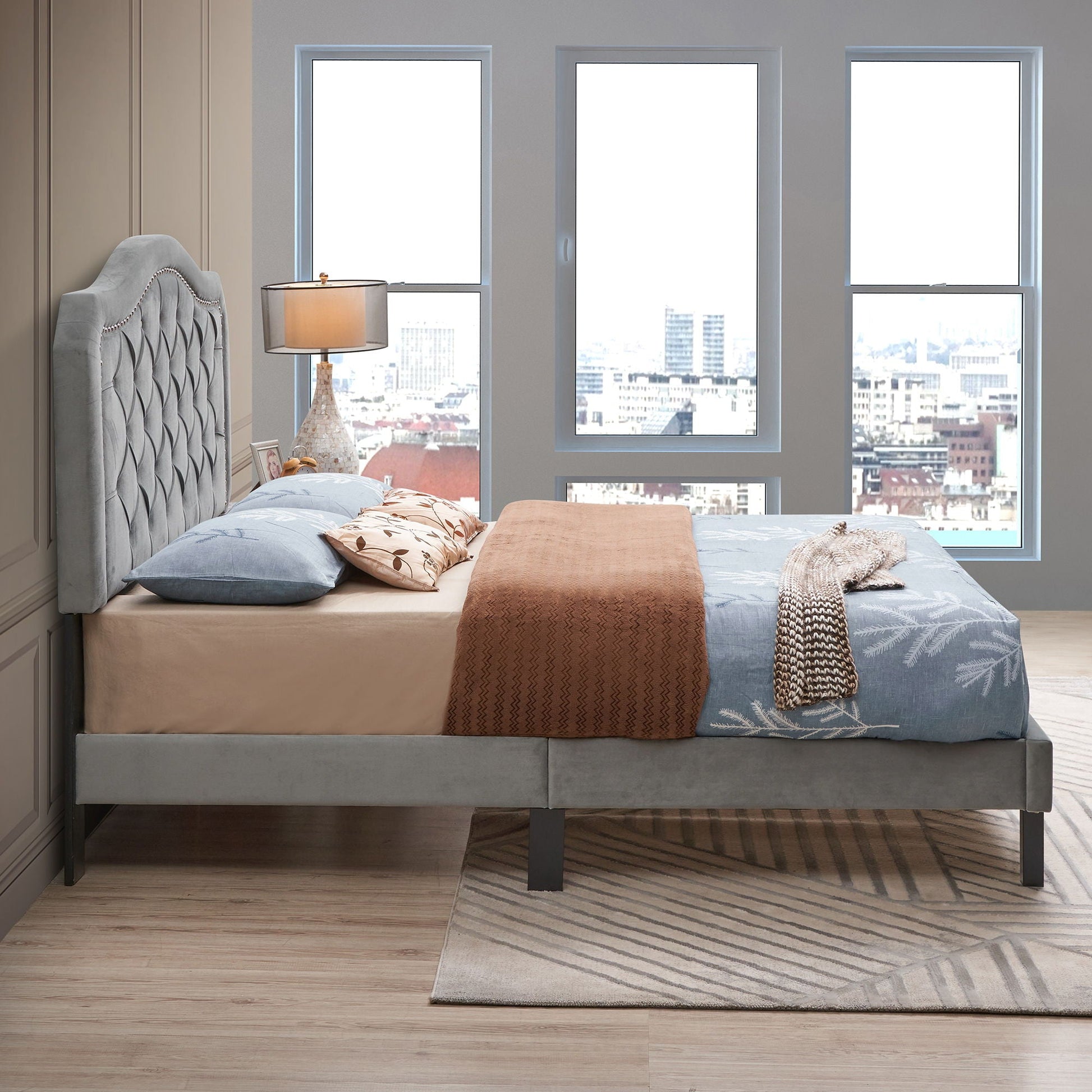 Queen platform upholstered bed with gray button-tufted curved headboard and wood base on Tampa Home & Garden Store