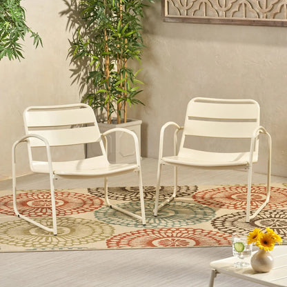 Conrad Outdoor Chair white metal arm chairs on a patio with a colorful circular rug on Tampa Home & Garden Store