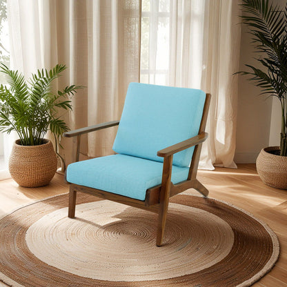 Genuine Lounge Chair with solid wood frame and light blue cushions on a rug beside plants on Tampa Home & Garden Store