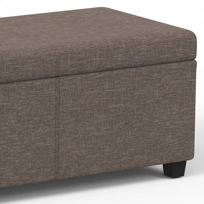 Avalon storage ottoman bench in brown textured fabric with lift-top lid and dark wood legs on Tampa Home & Garden Store