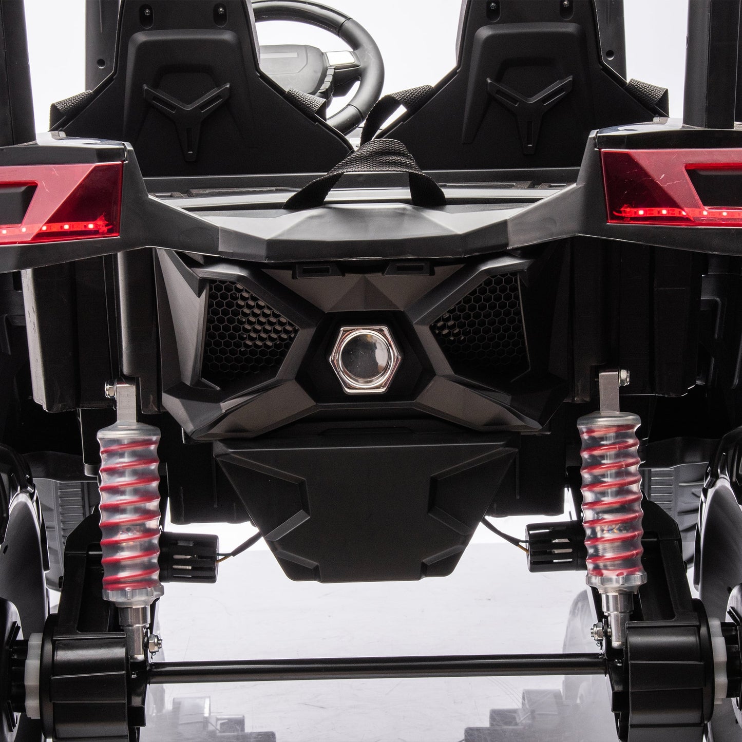 Side-by-side 4x4 ride-on off-road truck with dual seats, black body and red shocks on Tampa Home & Garden Store