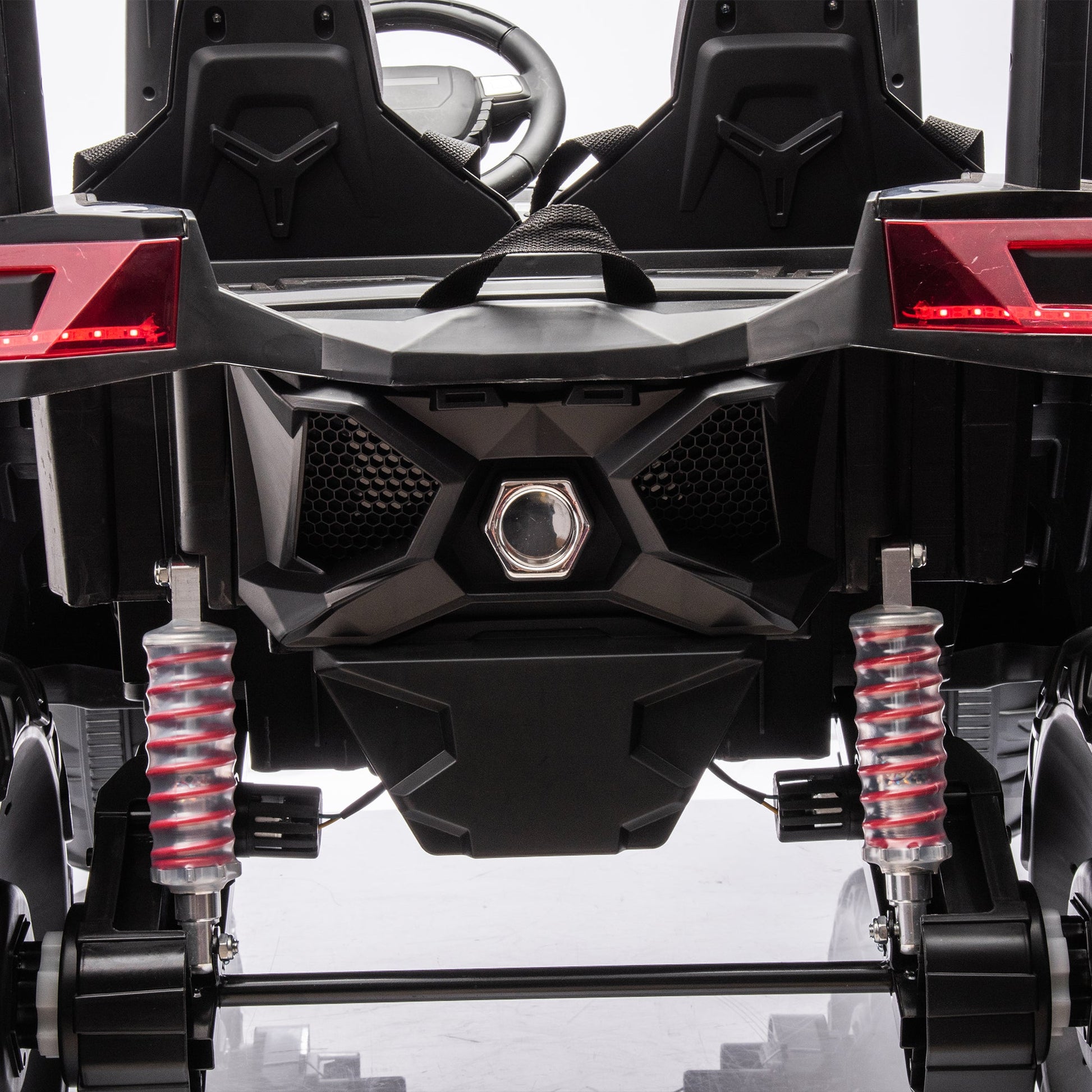 Side-by-side 4x4 ride-on off-road truck with dual seats, black body and red shocks on Tampa Home & Garden Store