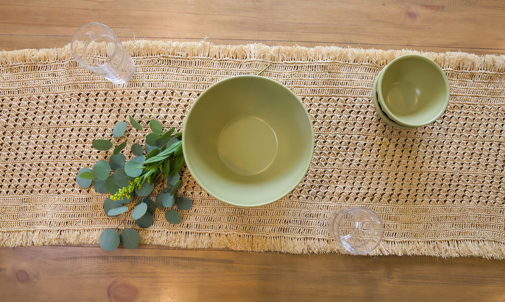 Lazio Crochet Raffia Table Runner by Payton James with olive green bowls on a woven surface on Tampa Home & Garden Store