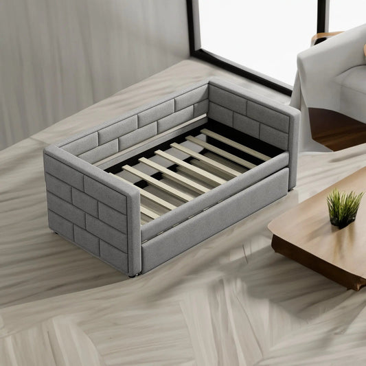 Twin daybed with trundle in gray upholstery featuring padded side panels and a wooden slat base on Tampa Home & Garden Store