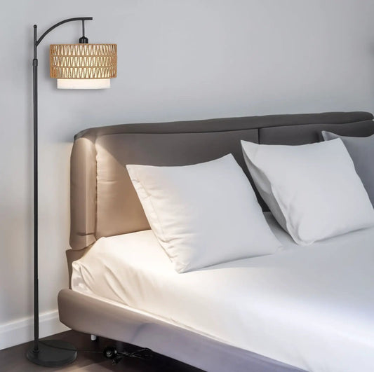 Arc floor lamp with remote and dimmable bulb, black metal stand and rattan shade beside bed on Tampa Home & Garden Store