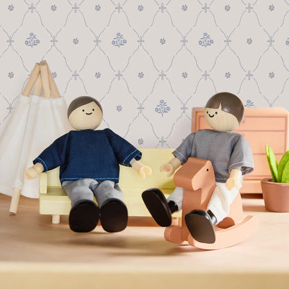 Tiny Land Sweetwood Dollhouse Dolls; two wooden dolls in blue and gray on a yellow sofa on Tampa Home & Garden Store
