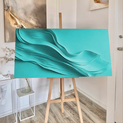 Turquoise minimalist wall art canvas by Tailored Canvases on an easel in a bright room on Tampa Home & Garden Store