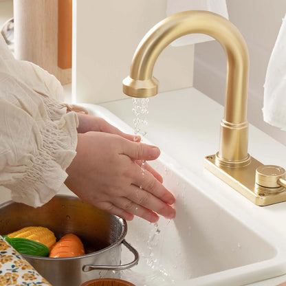 Tiny Land play kitchen with running water; gold faucet over white sink, child washing hands on Tampa Home & Garden Store