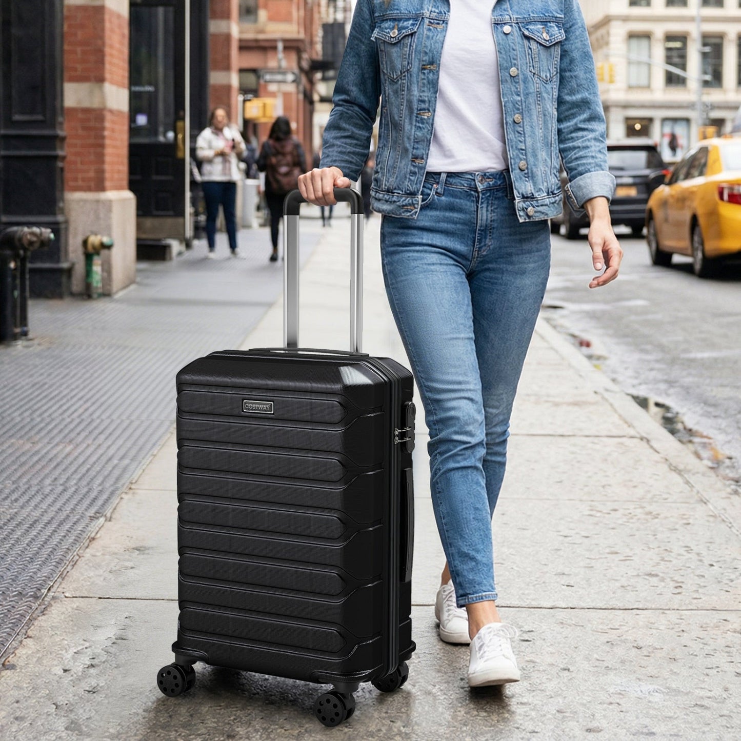 3-Piece hardside luggage set GemGear black suitcases with 8-spinner wheels on city sidewalk on Tampa Home & Garden Store