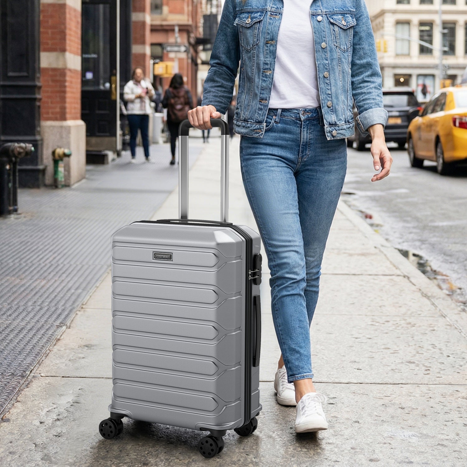 GemGear 3-Piece Hardside Luggage Set silver suitcase with 8-spinner wheels on city street on Tampa Home & Garden Store