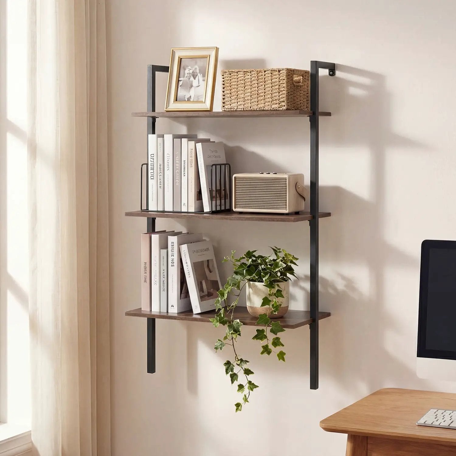 3-Tier wall-mounted ladder bookshelf in rustic brown with a black metal frame, holding several books, framed photo, wicker basket, vintage radio, and trailing plant on Tampa Home & Garden Store