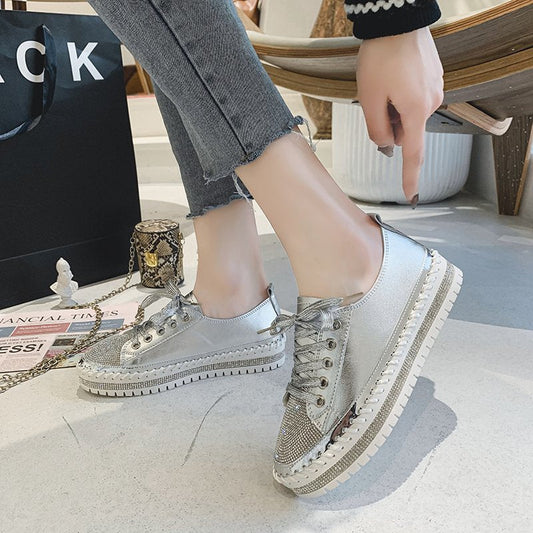 Sneakers in silver with rhinestone toe, lace-up front, and chunky platform sole on gray jeans on Tampa Home & Garden Store