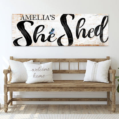 Personalized She Shed Sign canvas; white bg with bold black script and butterfly accent on Tampa Home & Garden Store