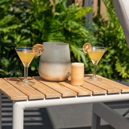 Portals Light C-Shape Side Table with light wood slats on a white frame on a sunny patio on Tampa Home & Garden Store