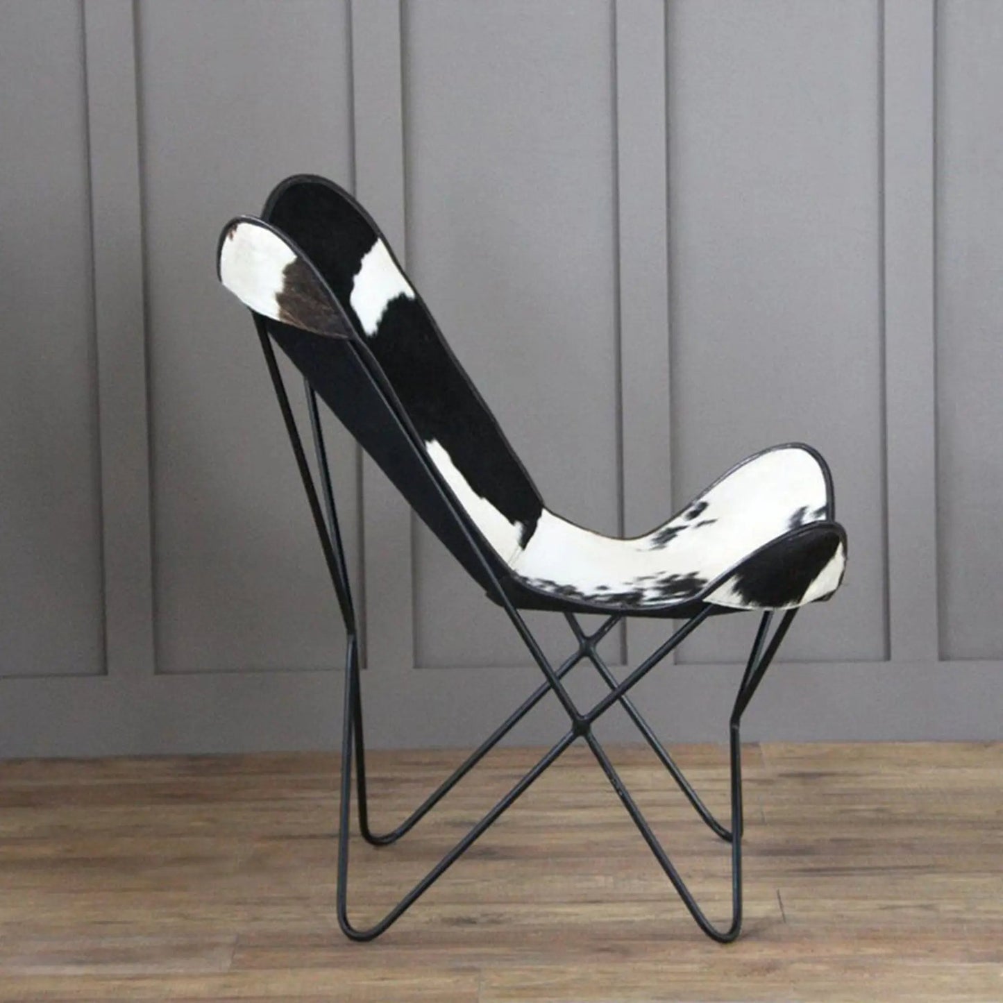 The Holsteins Butterfly Chair with black-and-white cowhide seat on a metal frame on Tampa Home & Garden Store