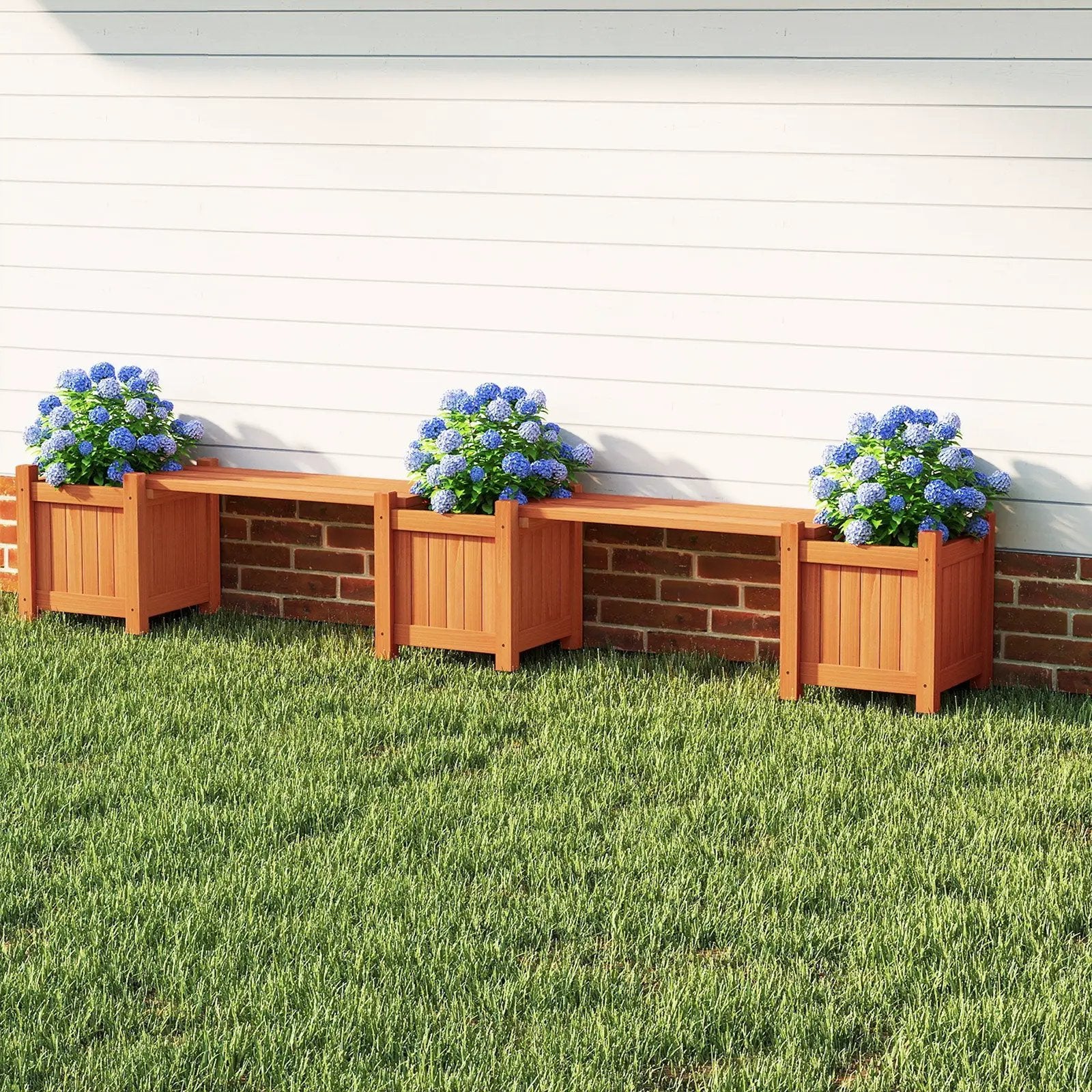 Three orange 3-in-1 planter boxes form a bench with side beds, blue hydrangeas on Tampa Home & Garden Store