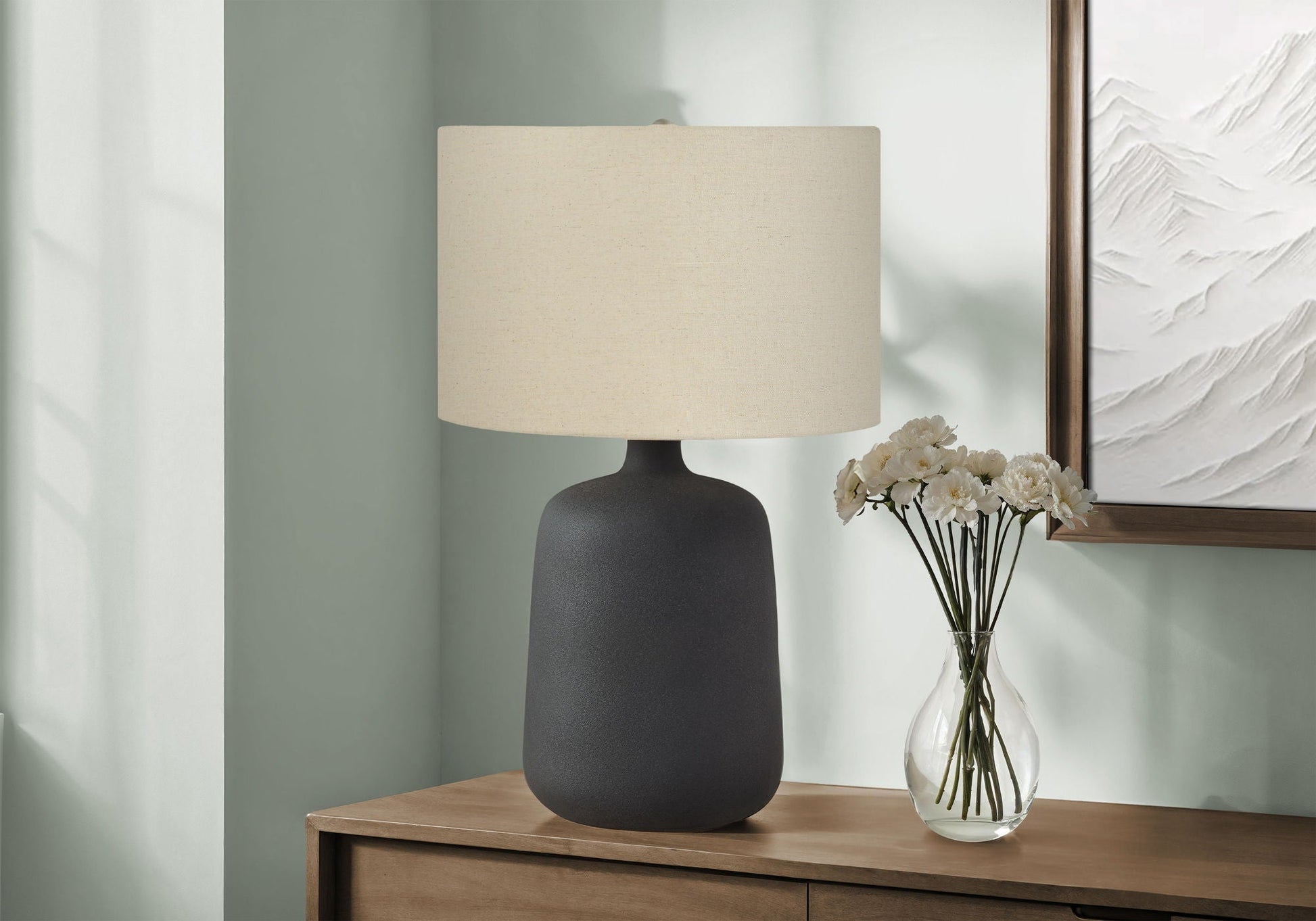Contemporary black table lamp with beige fabric shade on a wooden dresser HouseOfZazla on Tampa Home & Garden Store
