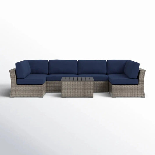 Wicker sectional sofa with navy cushions and table set by Unique Piece Furniture on Tampa Home & Garden Store