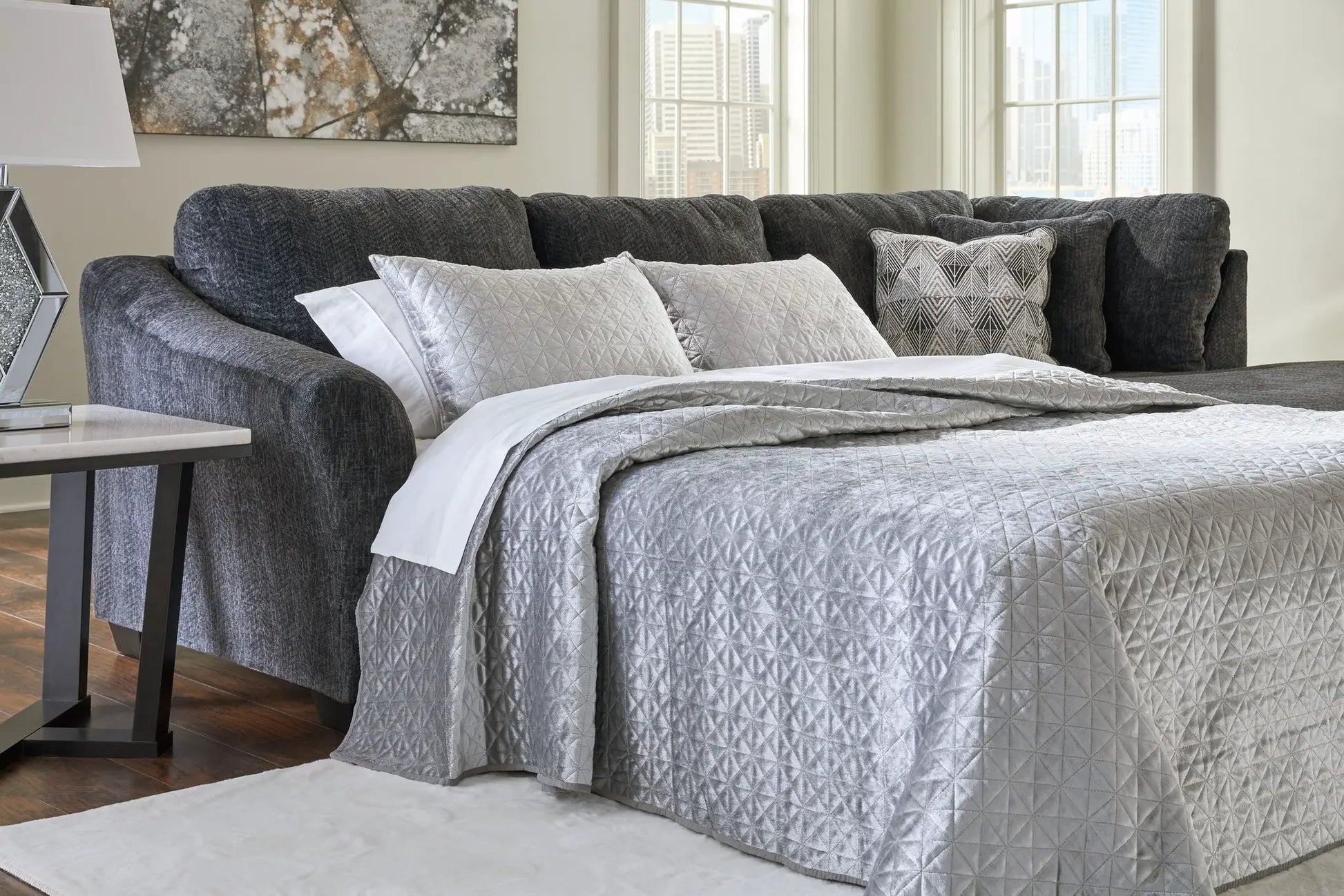 Biddeford stationary sectional sofa in dark gray fabric with quilted pillows on Tampa Home & Garden Store
