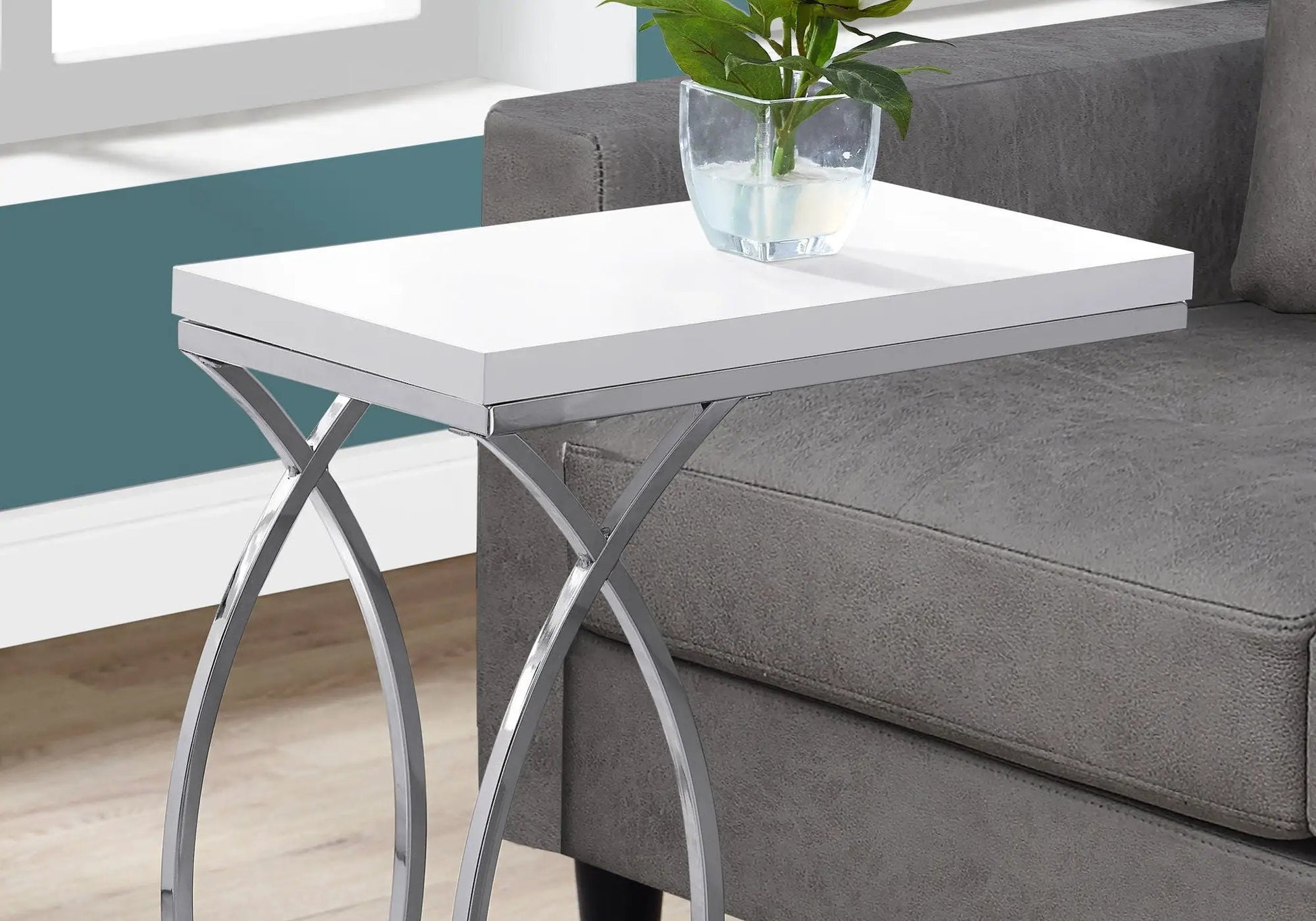 C-shaped accent table with white top and chrome X-frame legs beside a gray sofa on Tampa Home & Garden Store