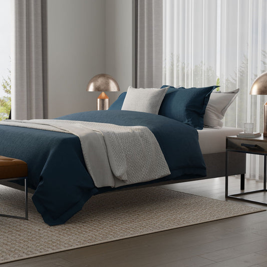Knock Down Mattress Foundation shown in a modern bedroom with navy bedding and slim metal frame on Tampa Home & Garden Store