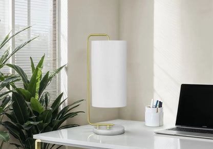 Table lamp with white fabric shade and gold curved frame on marble base on Tampa Home & Garden Store