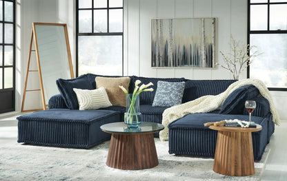 Bales Sectional navy blue corduroy with ottoman and cream knit throw in bright living room on Tampa Home & Garden Store